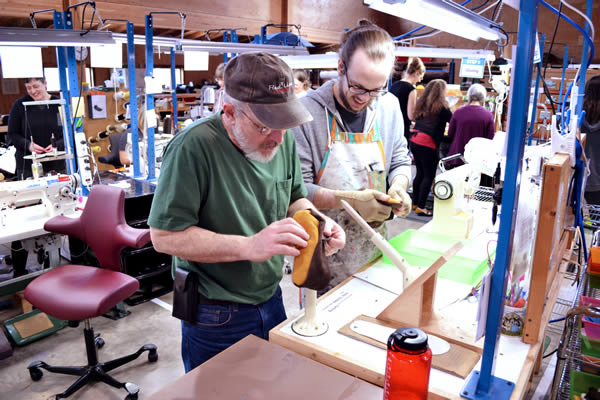 katy-bowman-moccasin-making-workshop Putting the finishing touches on a pair of moccasins